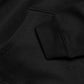 A close-up view of a black hoodie, showing the fabric and details of the garment.